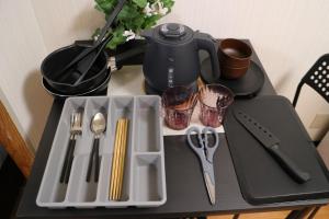 a tray with a tea kettle and utensils on a table at Silver Heights 3rd floor 302,303,304 - Vacation STAY 60218v in Osaka