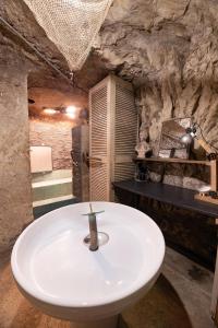 a bathroom with a white sink in a cave at Le Cavernacle in Montrichard