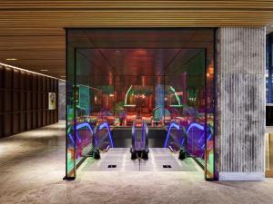 a dining room with purple chairs in a building at Mondrian Seoul Itaewon in Seoul