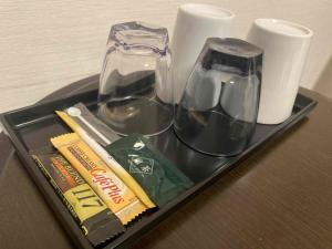 a tray with two glasses and other items on a table at Smile Hotel Premium Kanazawa Higashiguchi Ekimae - Vacation STAY 65337v in Housai