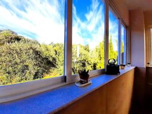 a room with a window with a view of trees at Casa Rural Arrebol - Barbacoa y piscina in Aracena