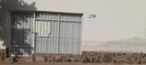 a metal door on a building with a wall at Kallpa in Tinogasta