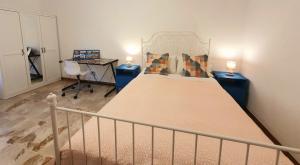 a bedroom with a bed and a desk with two lamps at Fiori e Frutti Locazione Turistica in Almese