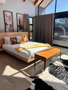 a bedroom with a bed and a large window at Makonde river lodge in Makonde +9 photos