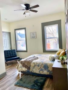 a bedroom with a bed and a ceiling fan at Perfect 6BR Stay Near Falls & Attractions in Niagara Falls