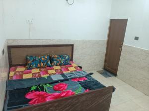 a bedroom with a bed with a quilt and pillows at Shri Ram Janam Homestay 300 Meter from Ram Mandir in Ayodhya +29 photos