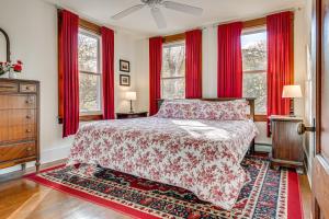 a bedroom with a bed with red curtains and a rug at Spacious Home on Bear Camp River in Tamworth! in Tamworth