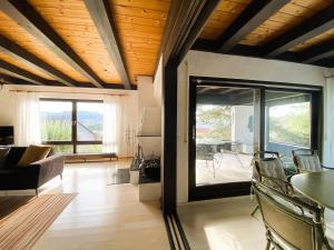 a living room with a couch and a table with chairs at Ferienwohnung Blautalblick in Blaustein