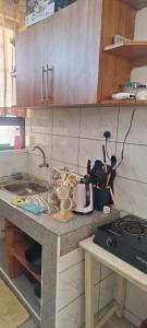 a kitchen with a sink and a counter top at Cozy one bedroom in Mombasa