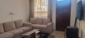 a living room with a couch and a table at Cozy one bedroom in Mombasa