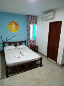 Postel nebo postele na pokoji v ubytování Hotel Los Arcangeles