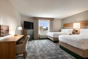 a hotel room with two beds and a desk and a television at Candlewood Suites Annapolis by IHG in Annapolis +58 photos
