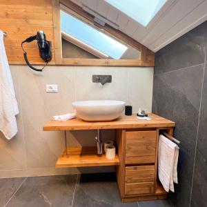 a bathroom with a sink on a wooden counter at Harmonia Suite & Apartments in Giustino +33 photos