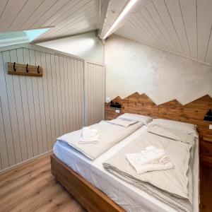 a bedroom with a bed with towels on it at Harmonia Suite & Apartments in Giustino