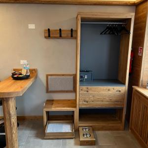 a kitchen with a wooden cupboard and a table at Harmonia Suite & Apartments in Giustino