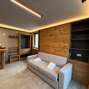 a living room with a couch and a television at Harmonia Suite & Apartments in Giustino