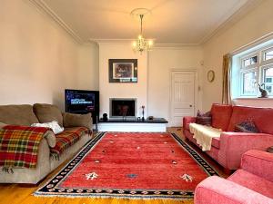 a living room with two couches and a red rug at Spacious 4-Bed Home - Oswestry - Families & Groups in Oswestry