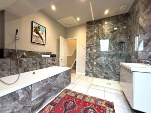 a large bathroom with a tub and a shower at Spacious 4-Bed Home - Oswestry - Families & Groups in Oswestry +22 photos