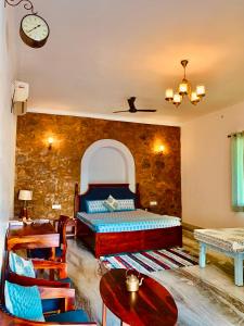 a bedroom with a bed and a table and chairs at Sayar Bagh Jawai in Nāna