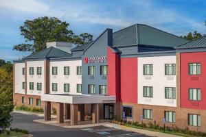 an architectural rendering of a hotel with red and white buildings at Candlewood Suites Annapolis by IHG in Annapolis