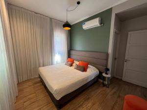 a bedroom with a bed and a green wall at Huli B&B in Mendoza +78 photos