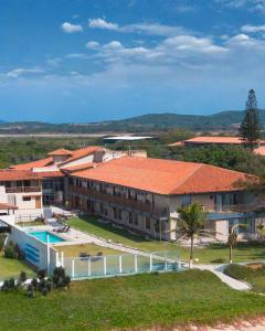 an aerial view of a resort with a swimming pool at HANNA Búzios Al Mare Hotel in Búzios
