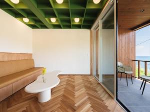 a living room with a couch and a table at umieru - Vacation STAY 50097v in Taiza