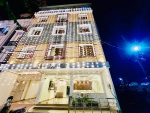 a tall building with lights on it at night at Hotel The Pacific Paradise,Near Jain Mandir - Haridwar in Haridwār