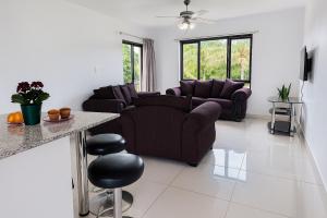 a living room with a couch and a table at Tranquil Shores Modern 1BR WiFi Pool Beach in Richards Bay