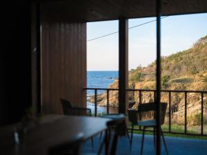 a view of the ocean from a room with a table and chairs at umieru - Vacation STAY 55238v in Taiza