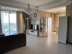 a living room with a couch and a television at Коттедж - Вилла in Chok-Tal