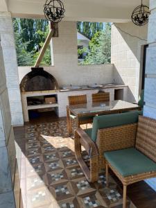 a patio with a table and chairs and an oven at Коттедж - Вилла in Chok-Tal