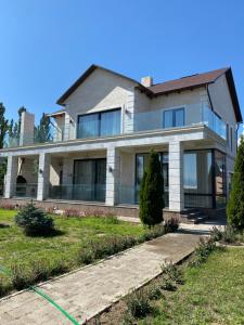 a house with a green hose in front of it at Коттедж - Вилла in Chok-Tal