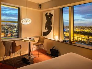 a hotel room with a view of a city at Too Hotel & Spa Paris - MGallery Collection in Paris +129 photos