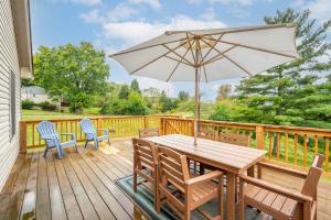a wooden table with an umbrella on a deck at Valley Ridge Retreat - For 8 in Cincinnati