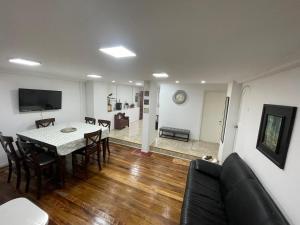 a dining room and living room with a table and chairs at Valparaiso's Best in Valparaíso