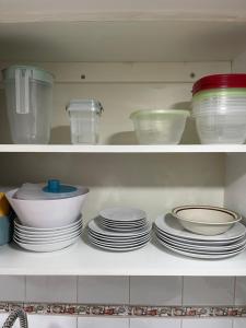 a shelf with plates and bowls and other dishes at Valparaiso's Best in Valparaíso