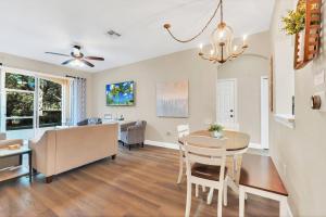 a dining room and living room with a table and chairs at Disney Bunk Room--Windsor Hills in Orlando