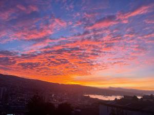 a sunset with a view of a city at Valparaiso's Best in Valparaíso