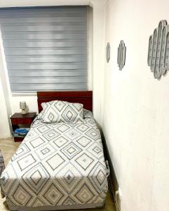 a bedroom with a bed in a room with a window at Valparaiso's Best in Valparaíso