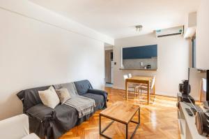 a living room with a couch and a table at Moderno departamento en Cañitas in Buenos Aires +2 photos