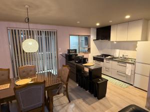 a kitchen with a table and a dining room at Plaisir Kumamoto - Vacation STAY 20334 in Hanabatachō