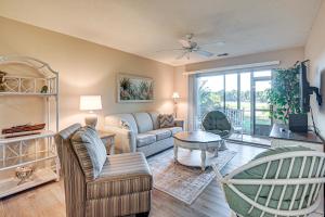 a living room with a couch and a table at Pawleys Island Condo with Screened Porch and Golfing! in Pawleys Island