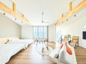 a living room with two beds and a couch at Ansolas-Villa - Vacation STAY 54282v in Tusi