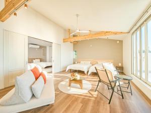 a living room with a white couch and a bedroom at Ansolas-Villa - Vacation STAY 54282v in Tusi