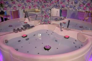 a jacuzzi tub with pink flowers in it at B&B Milù in Sant'Egidio del Monte Albino +42 photos