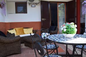 a patio with a table and chairs and a couch at B&B Milù in Sant'Egidio del Monte Albino