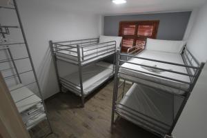 a room with two bunk beds and a ladder at For A Stay Don Quijote in Salou