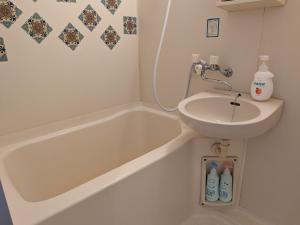 ein Badezimmer mit Waschbecken und Badewanne und Waschbecken in der Unterkunft Apartment Primeira Classe Room 1A - Vacation STAY 54531v in Imaichi + 24 Fotos