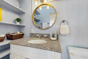 a bathroom with a sink and a mirror at Kahaone Ohana (30+ night rental) in Waialua +22 photos